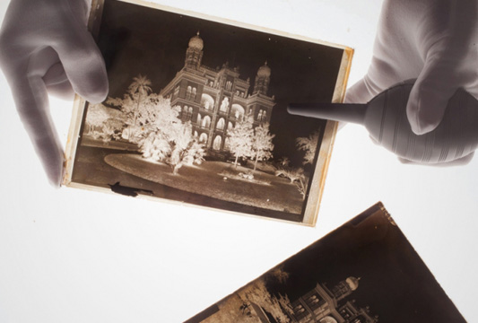 Foto de um arquivista trabalhando a preservação de uma fotografia