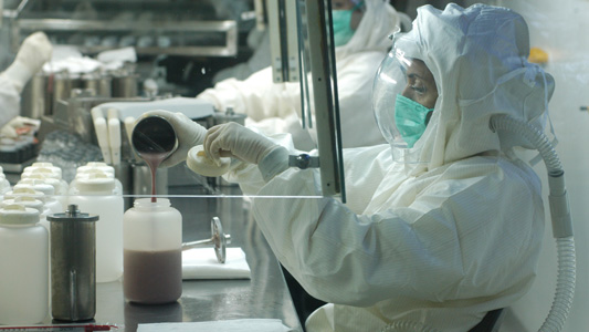 Farmacêutico trabalhando na produção de medicamentos em uma fábrica
